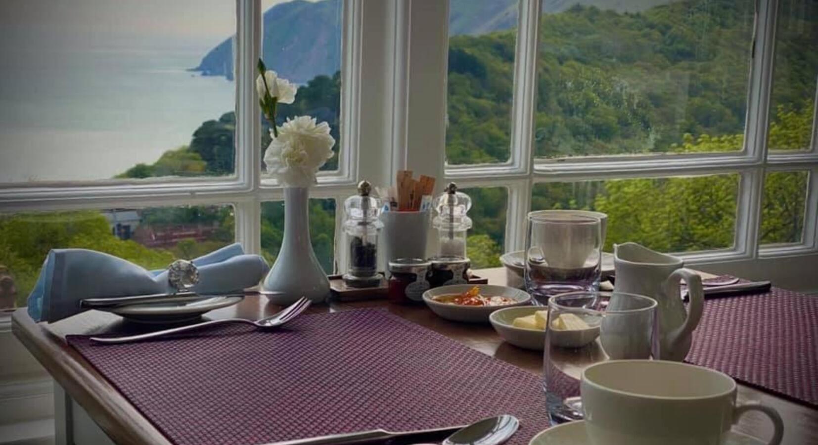 Breakfast views to Countisbury Hill from the Orangery Dining Room at Highcliffe House Devon