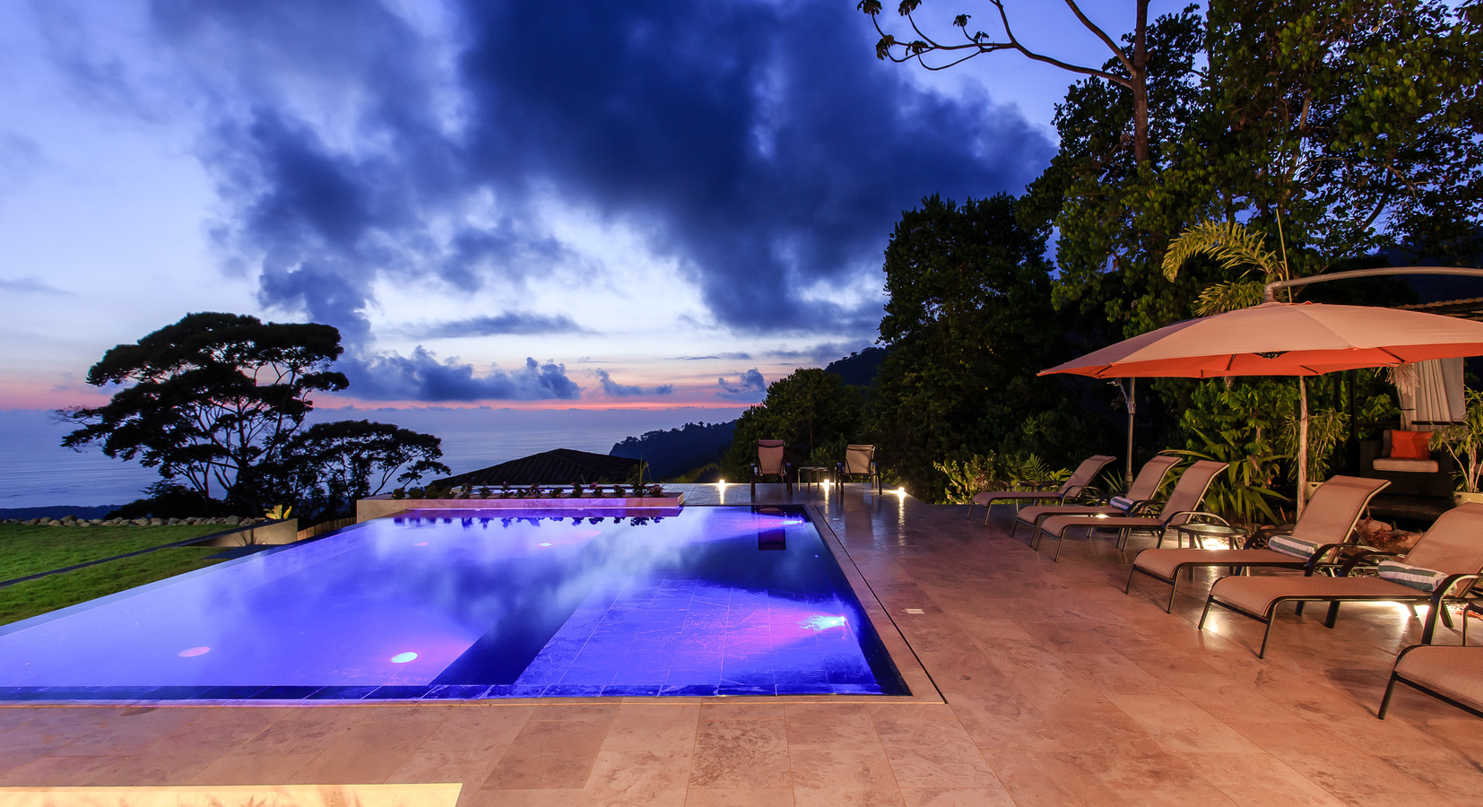 Pool and terrace under dramatic skies