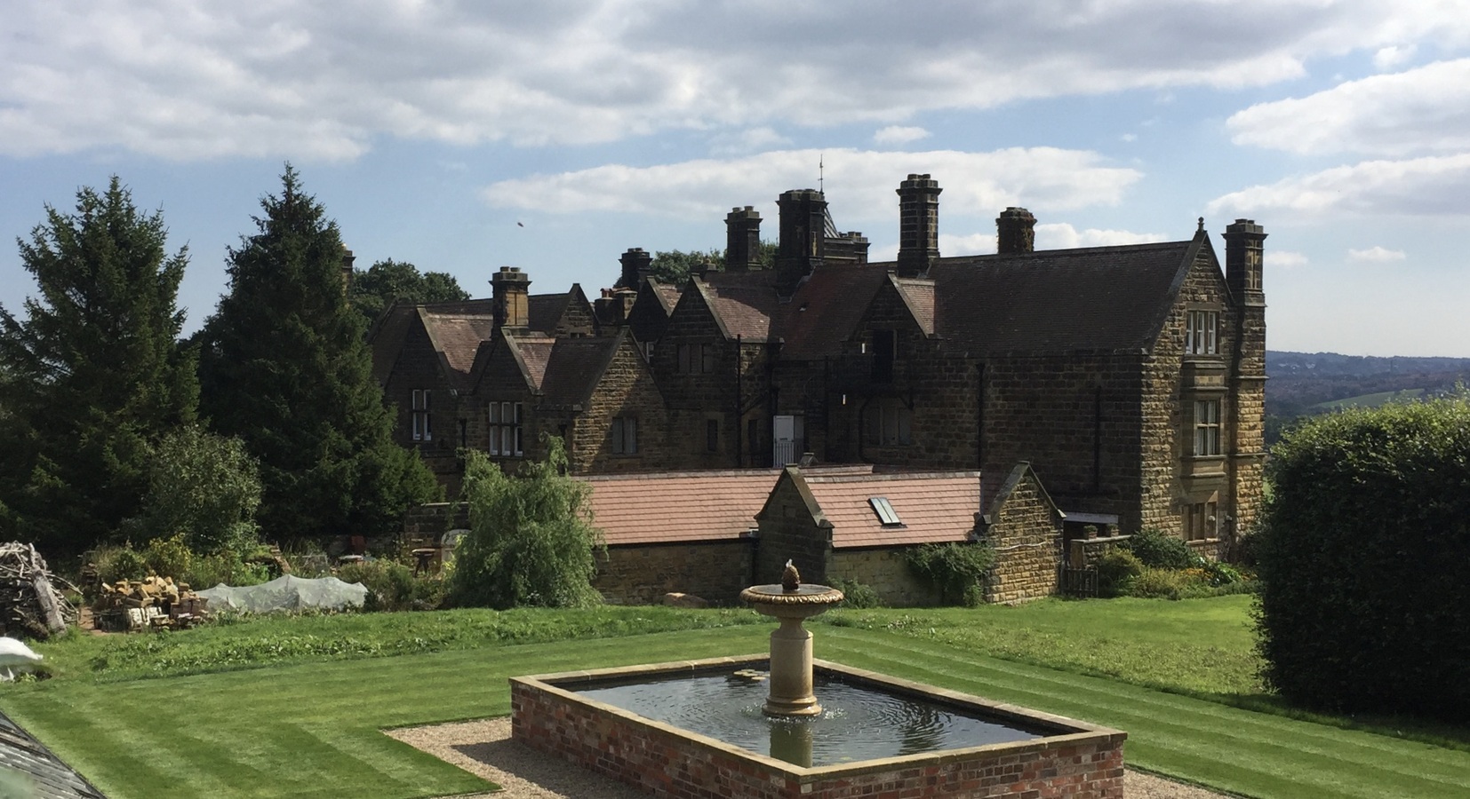 View over Kitchen Gardens and pond towards the mansion.