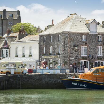 Exterior view of the gorgeous stone building right on the edge of the harbour