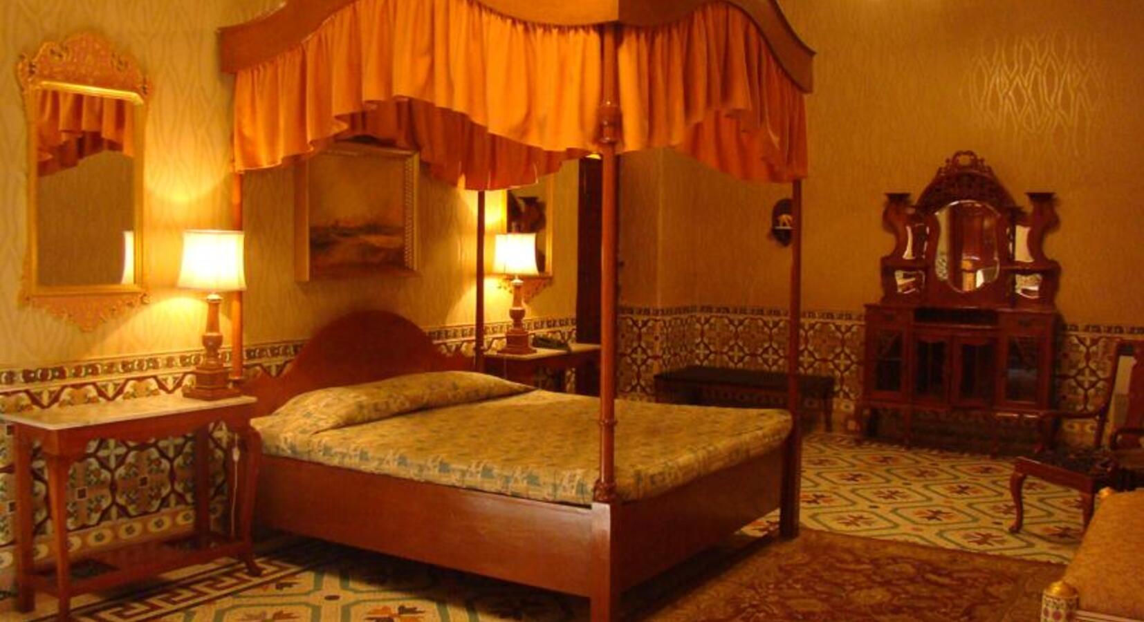 Bedroom with four poster bed and canopy