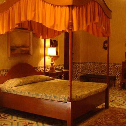 Bedroom with four poster bed and canopy