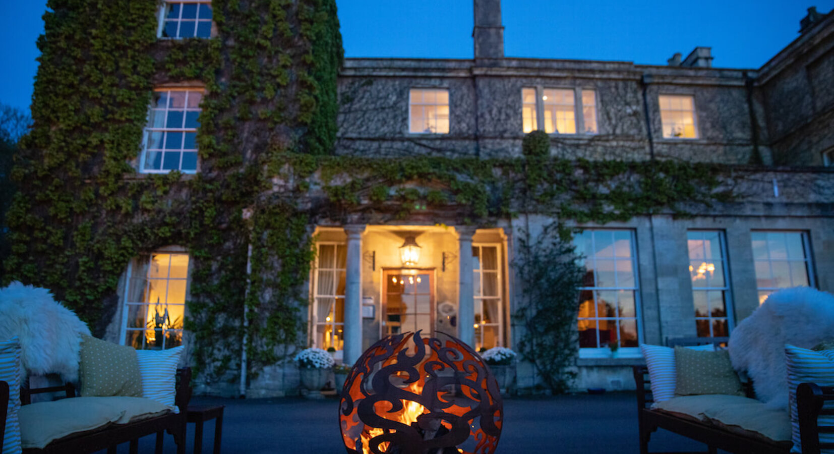 Manor house hotel exterior with fire pit